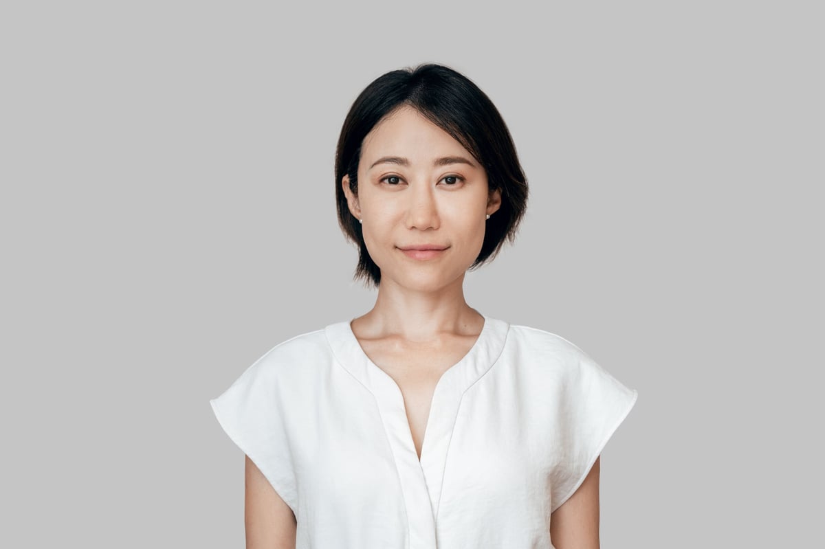 Isolated headshot portrait of confident mature female businesswoman